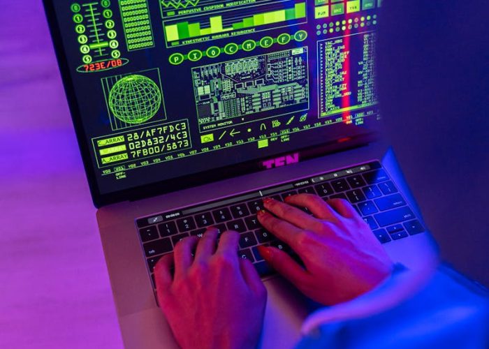 Person Using Macbook Pro on Pink Table